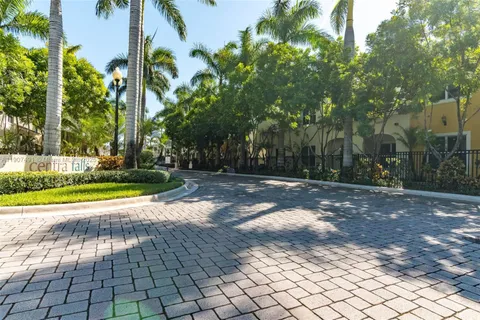 a view of a patio with table and chairs potted plants and palm tree