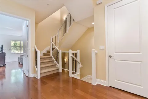 a view of entryway with wooden floor and stair