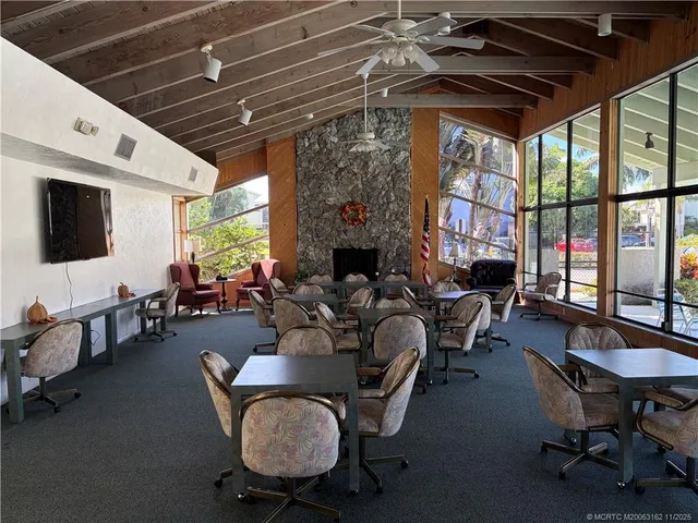 a living room with furniture a flat screen tv and a window