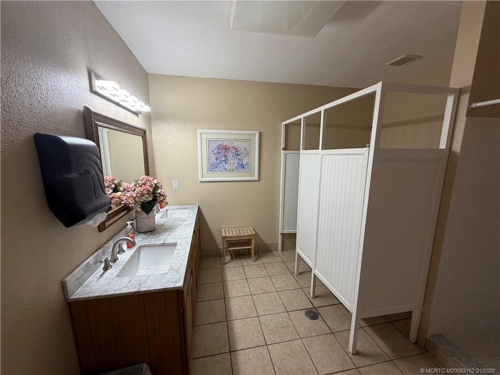 Undisclosed Address Stuart, FL 34994 - Photo 21 of 25 a bathroom with a sink and a mirror