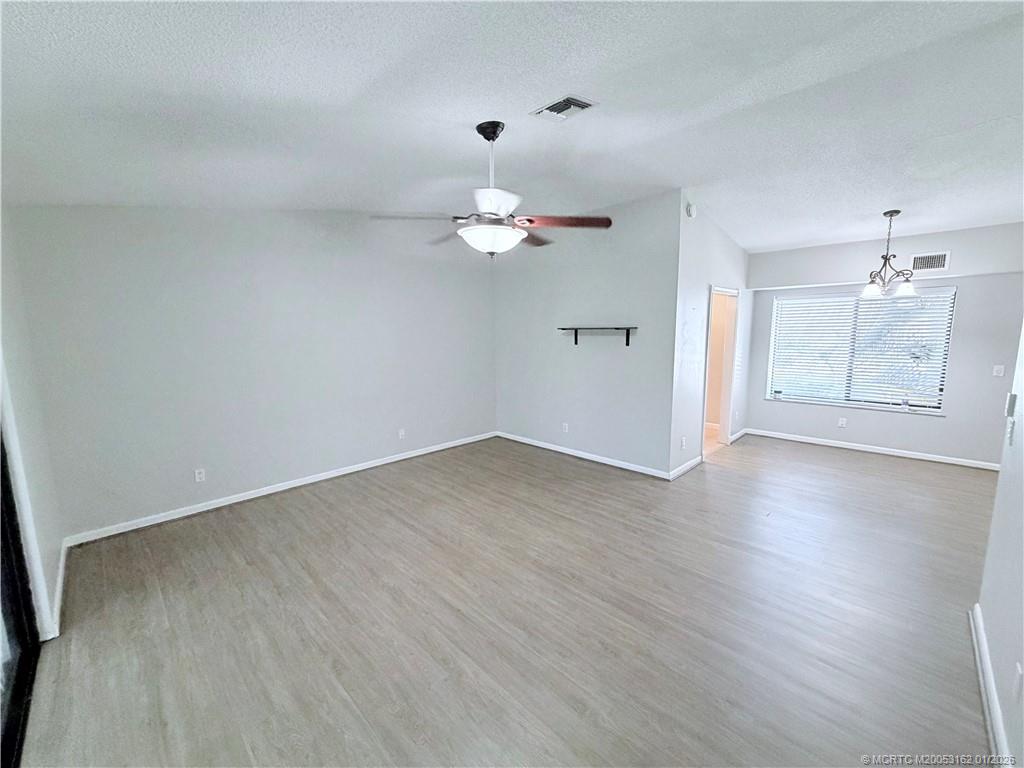 Undisclosed Address Stuart, FL 34994 - Photo 5 of 25 wooden floor in an empty room with a window