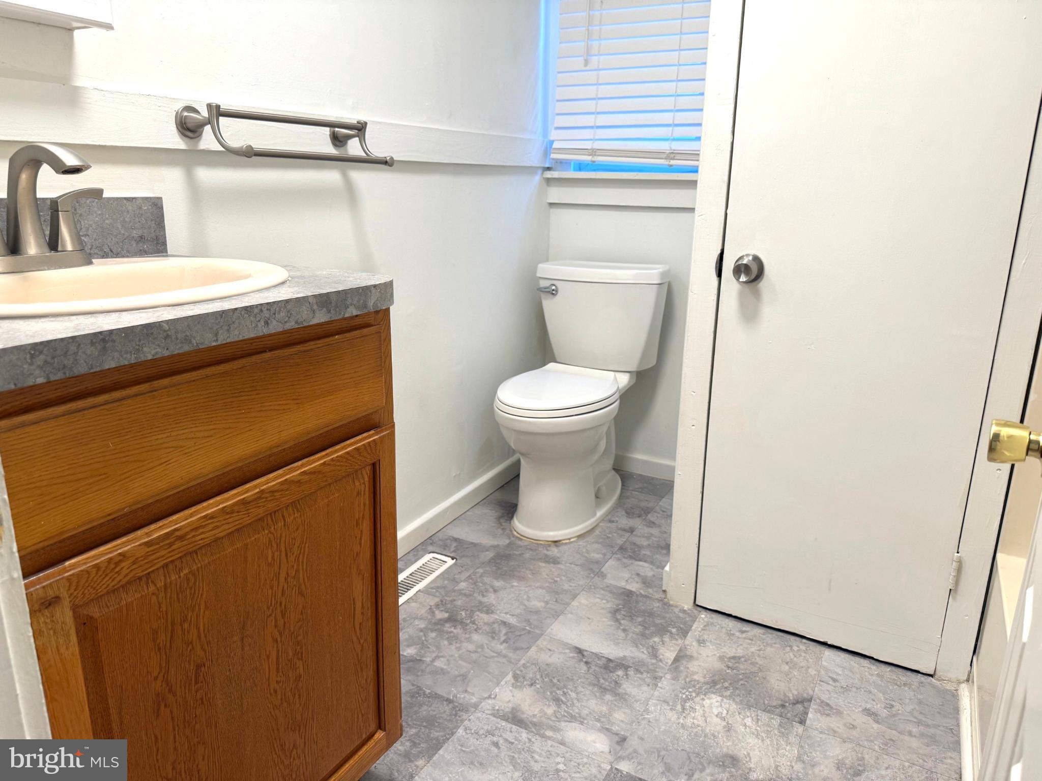 61 West W Pitman, NJ 08071 - Photo 6 of 9 a bathroom with a toilet and a sink