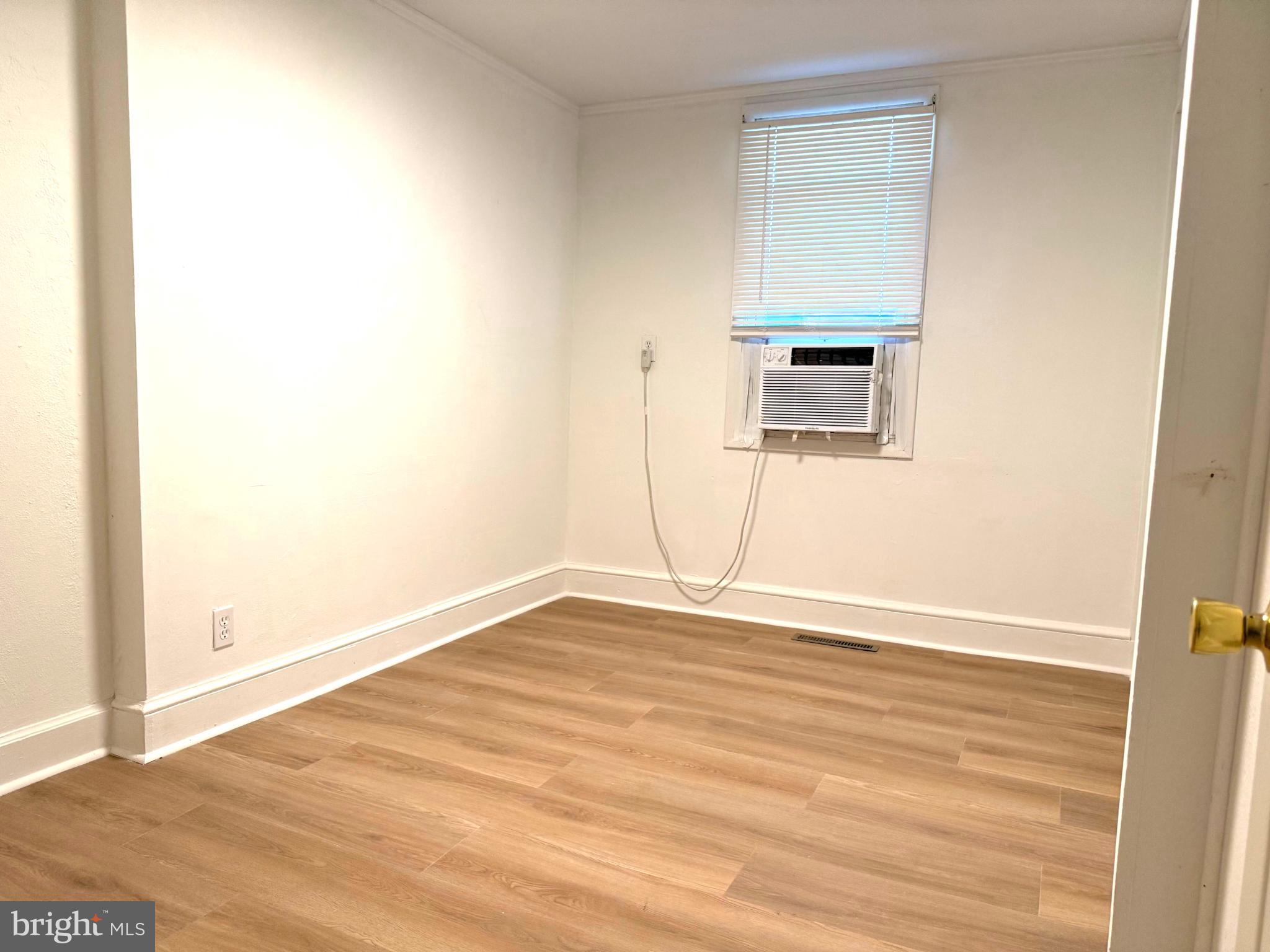 61 West W Pitman, NJ 08071 - Photo 8 of 9 an empty room with wooden floor and windows