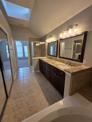 a large bathroom with a large tub and sink