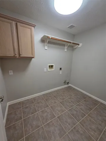 a view of a room with an empty space and a window