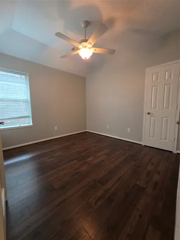 a view of wooden floor and windows in a room
