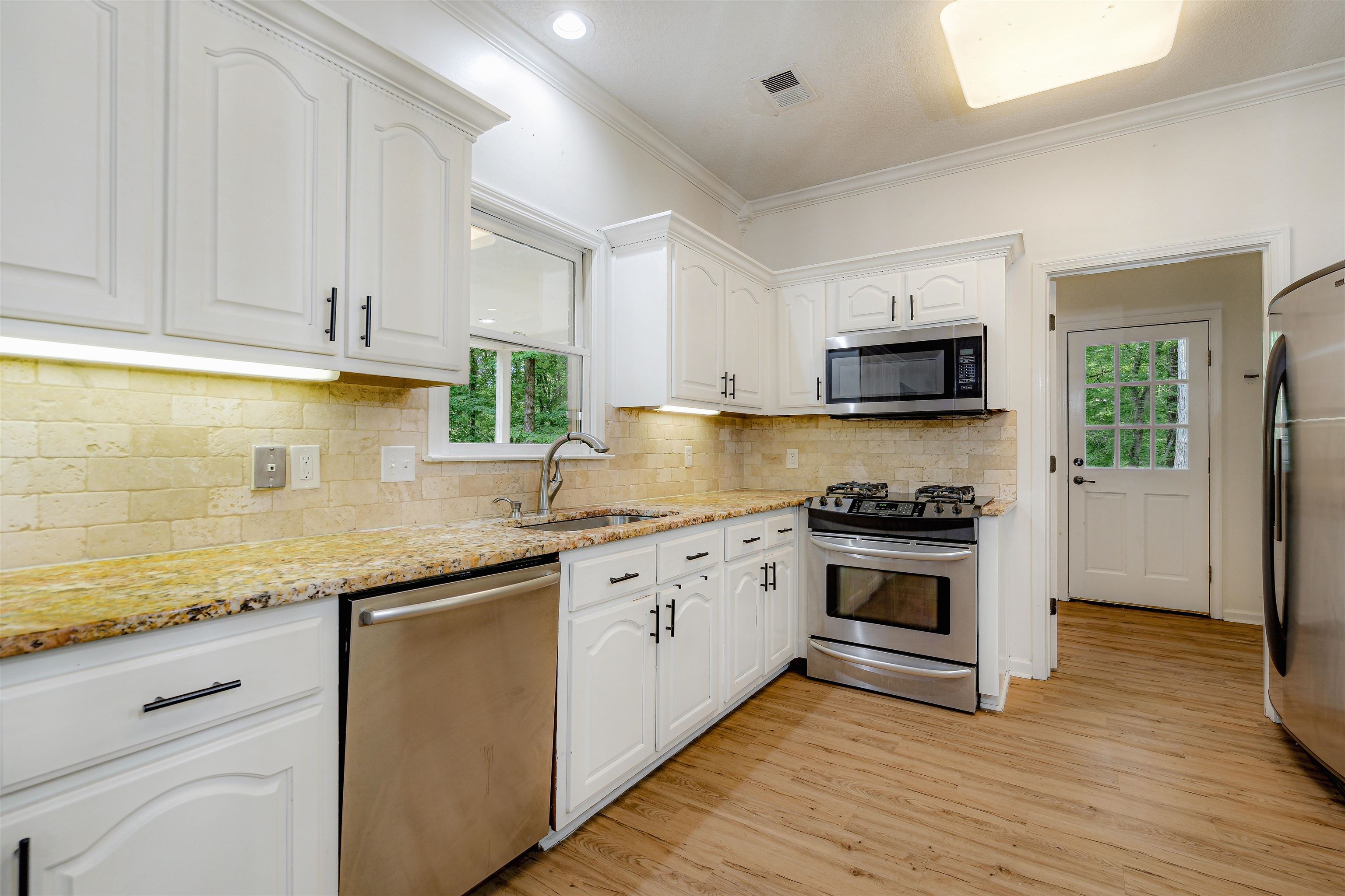 4020 Price Road Moscow, TN 38057 - Photo 13 of 35 Kitchen featuring visible vents, white cabinetry, a sink, appliances with stainless steel finishes, and a wealth of natural light