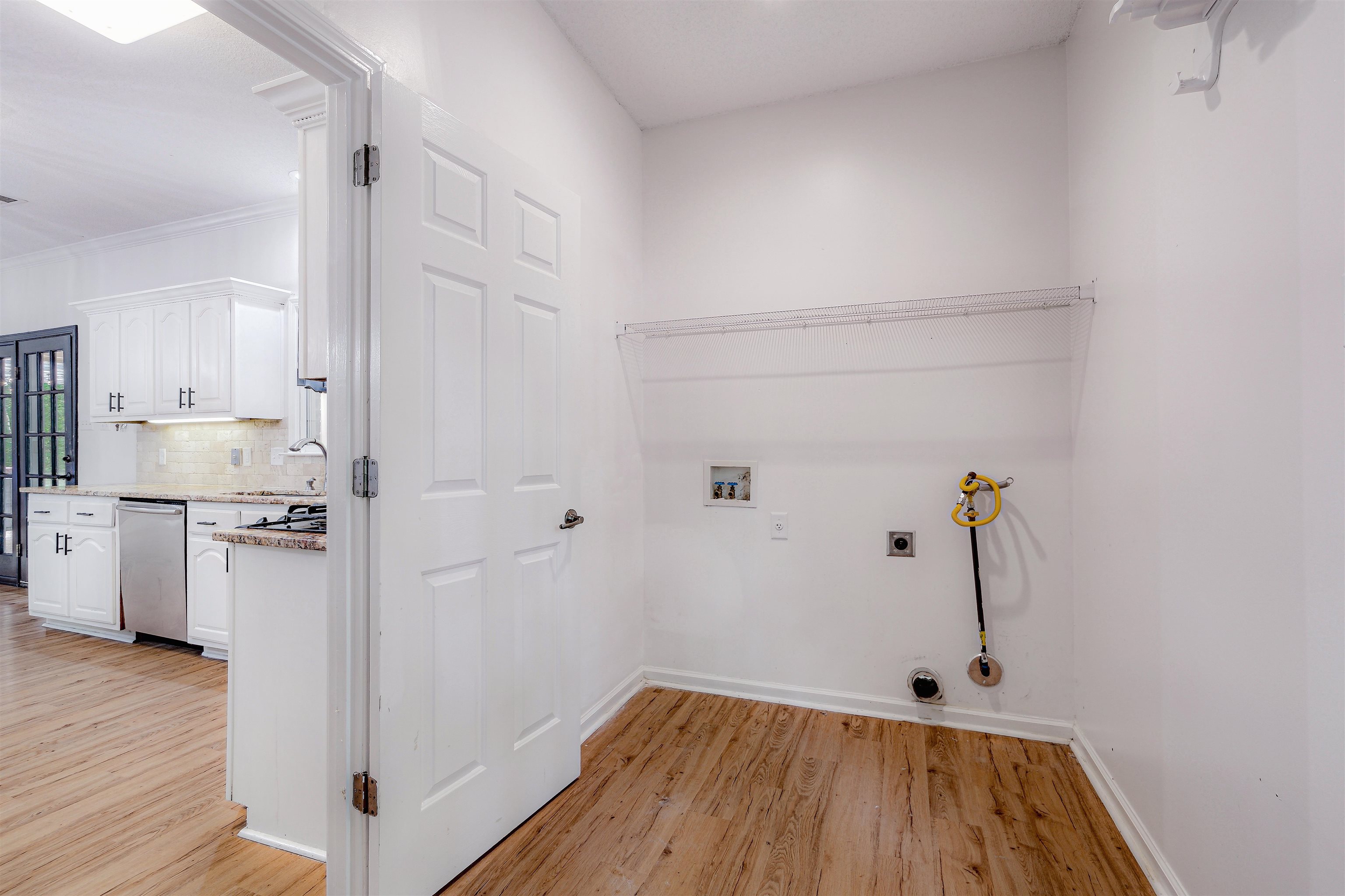 4020 Price Road Moscow, TN 38057 - Photo 16 of 35 Washroom featuring laundry area, washer hookup, baseboards, light wood-type flooring, and hookup for an electric dryer