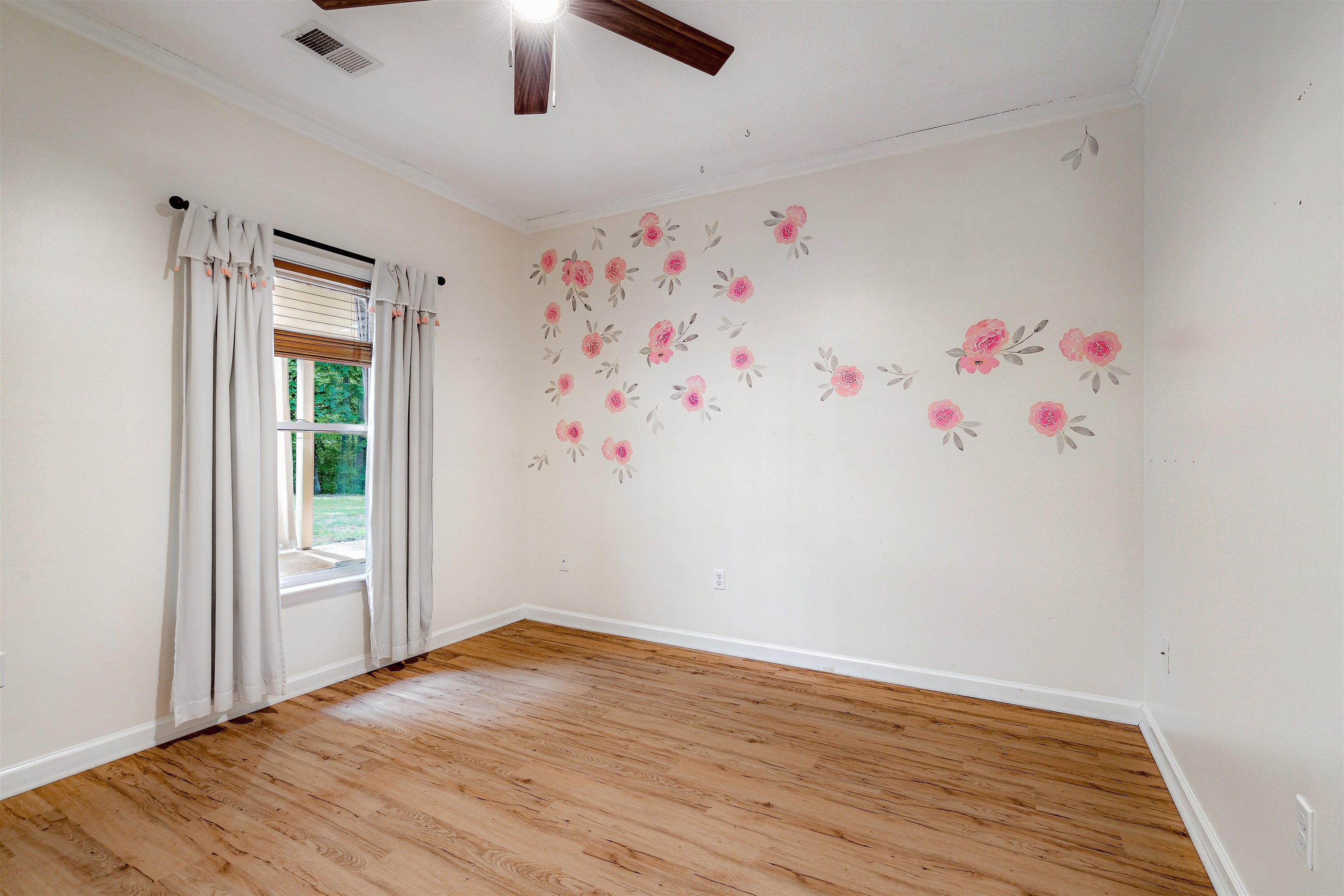 4020 Price Road Moscow, TN 38057 - Photo 24 of 35 Spare room with a ceiling fan, baseboards, light wood-type flooring, visible vents, and ornamental molding
