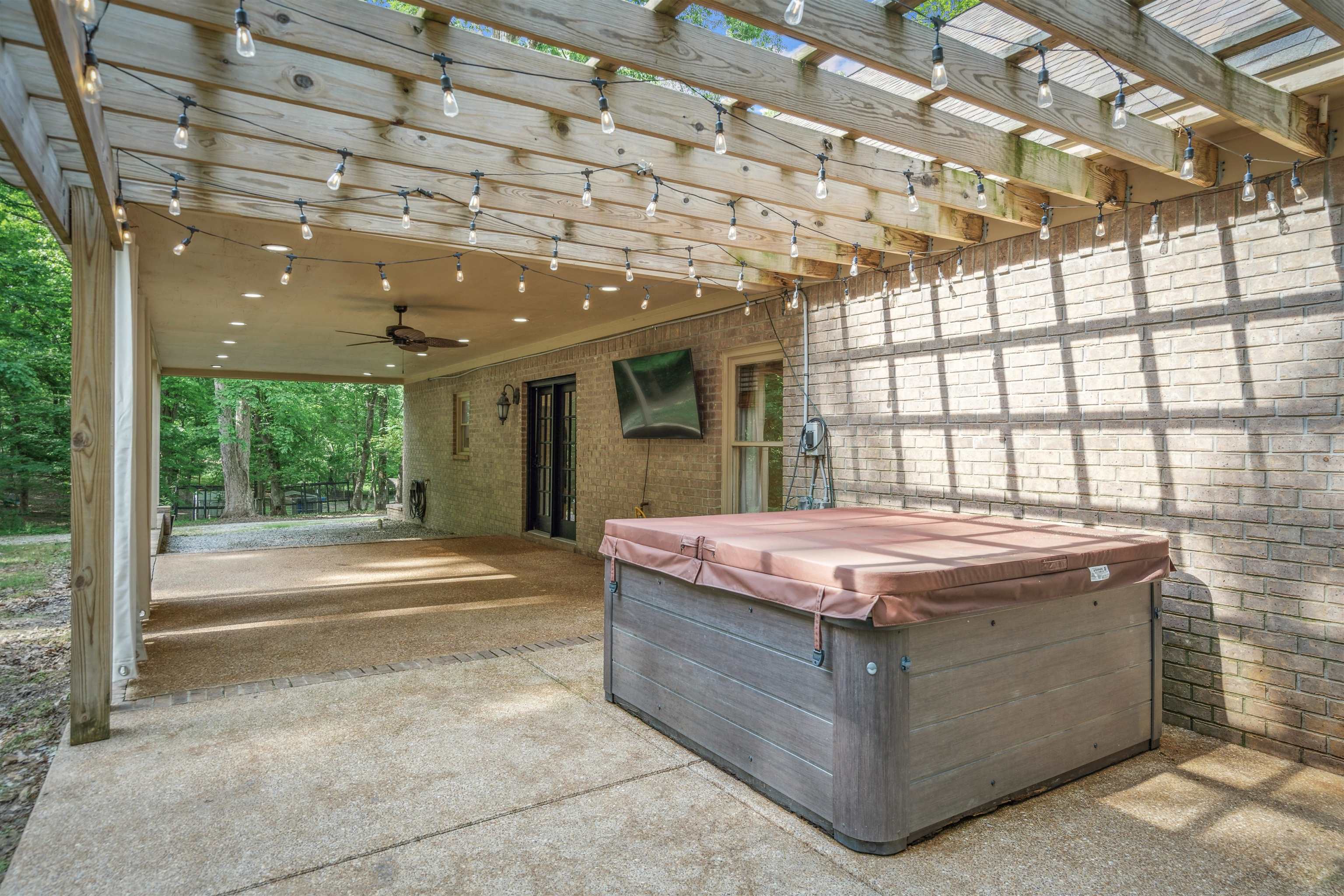 4020 Price Road Moscow, TN 38057 - Photo 30 of 35 View of patio / terrace featuring a ceiling fan, a hot tub, and a pergola