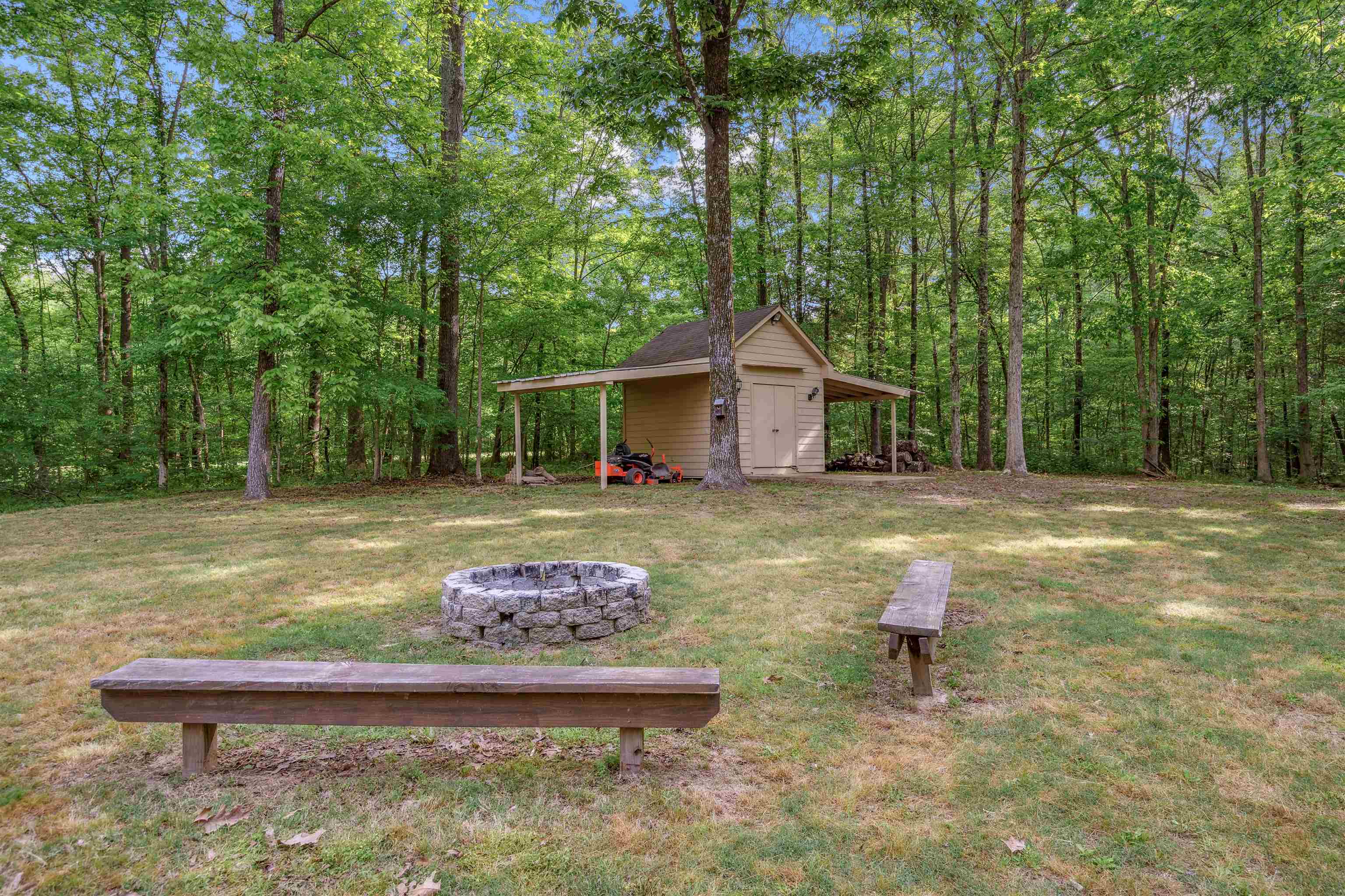 4020 Price Road Moscow, TN 38057 - Photo 34 of 35 View of yard featuring an outbuilding, an outdoor fire pit, and a wooded view