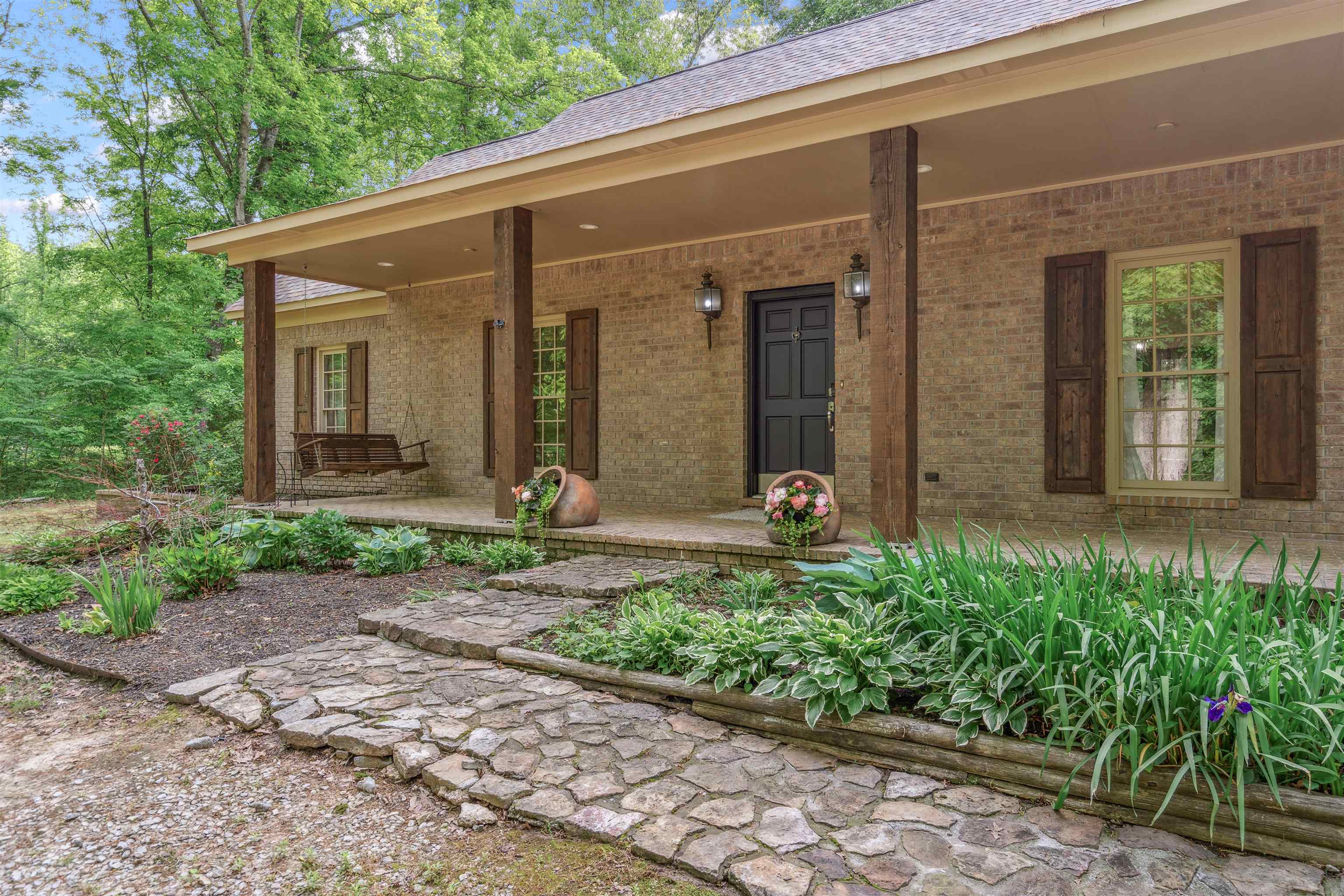 4020 Price Road Moscow, TN 38057 - Photo 5 of 35 View of exterior entry with covered porch, a shingled roof, and brick siding