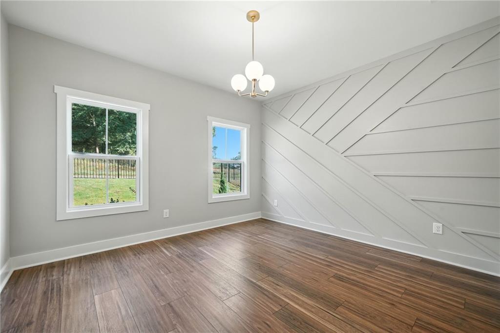 125 Old Alabama Road Southeast Emerson, GA 30137 - Photo 16 of 37 an empty room with wooden floor chandelier and windows