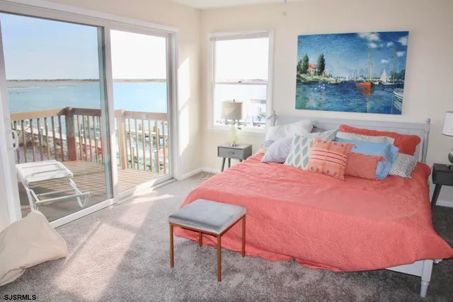 a bedroom with a bed and large window