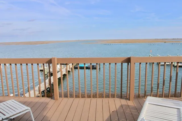 a view of a roof with wooden floor and fence