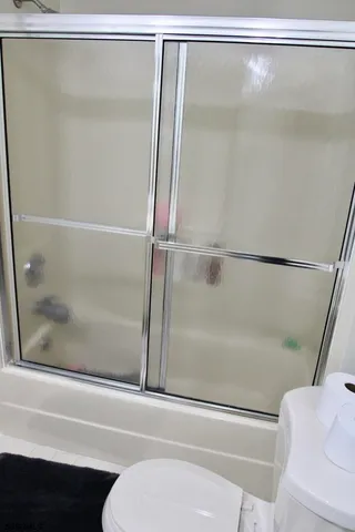 a bathroom with a shower and a toilet