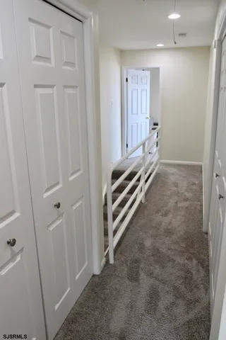 a view of room with stairs and a view of bathroom