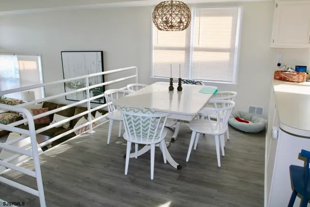 a dining room with furniture a rug and wooden floor