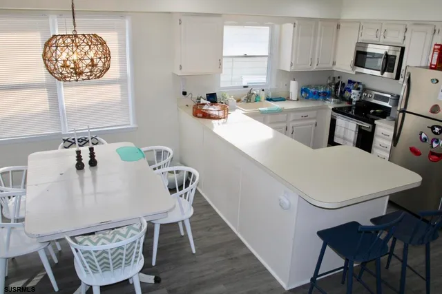 a view of kitchen with dining table and chairs