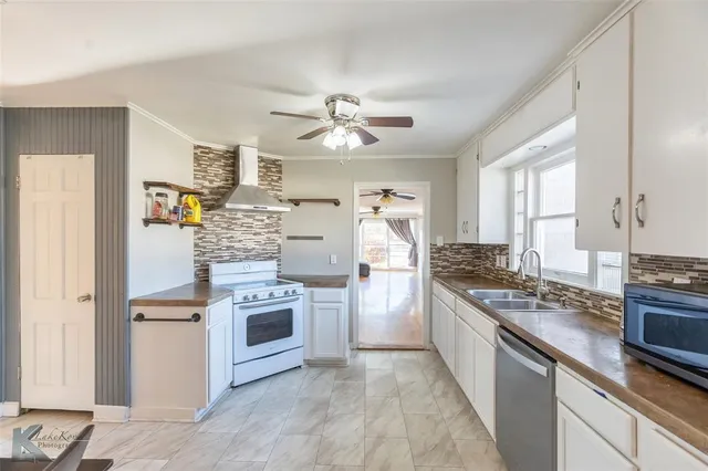 a kitchen with stainless steel appliances granite countertop a stove and a refrigerator