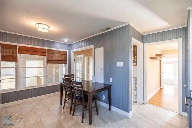 a view of a dining room with furniture and a window