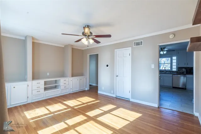 a view of a bedroom with furniture and natural light