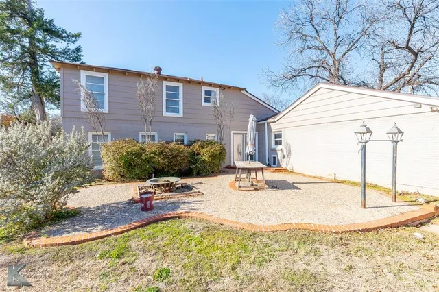 a view of a house with a snow in the yard
