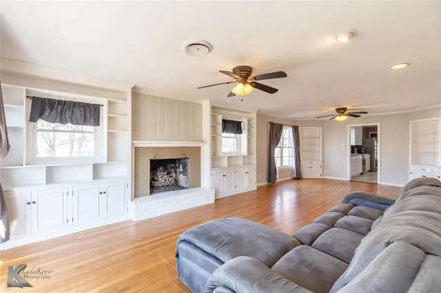 a living room with furniture fireplace and window