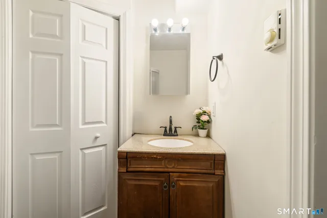 a bathroom with a sink vanity and a mirror