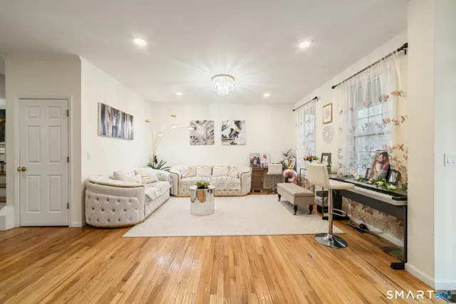 a living room with furniture and wooden floor