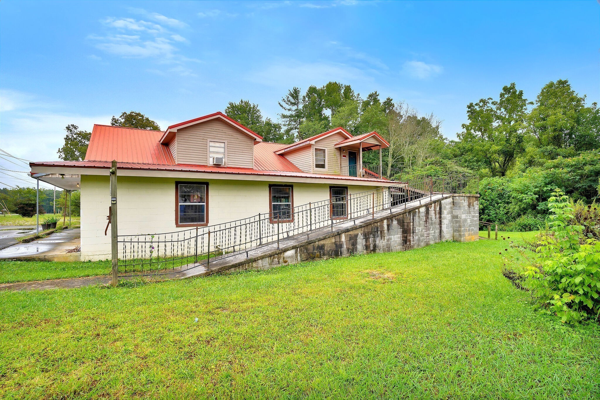 1183 Main Street Altamont, TN 37301 - Photo 2 of 52 a front view of a house with a garden and yard