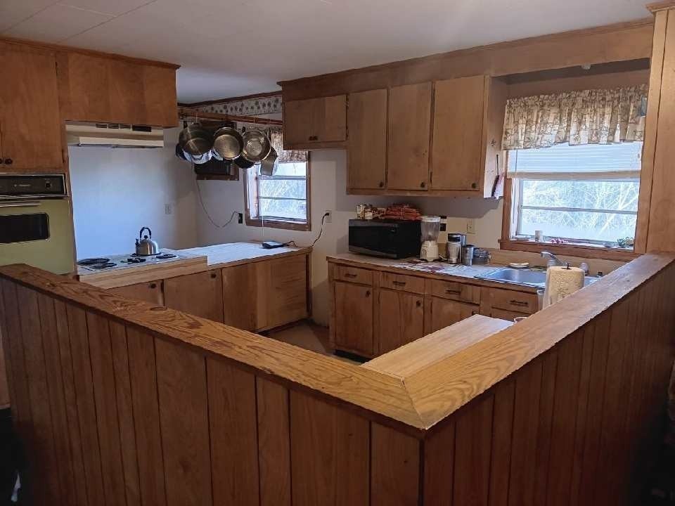 1183 Main Street Altamont, TN 37301 - Photo 21 of 52 a kitchen with stainless steel appliances a sink dishwasher a refrigerator and wooden cabinets