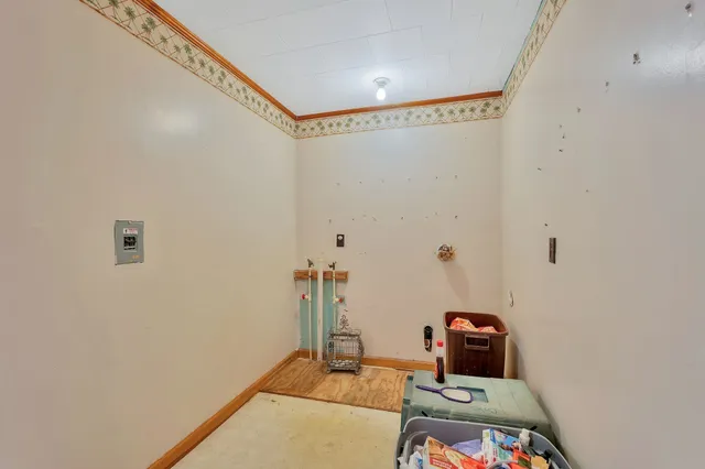 a room with a window and a kitchen view