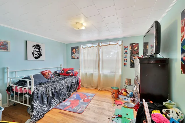 a bedroom with toys and wooden floor