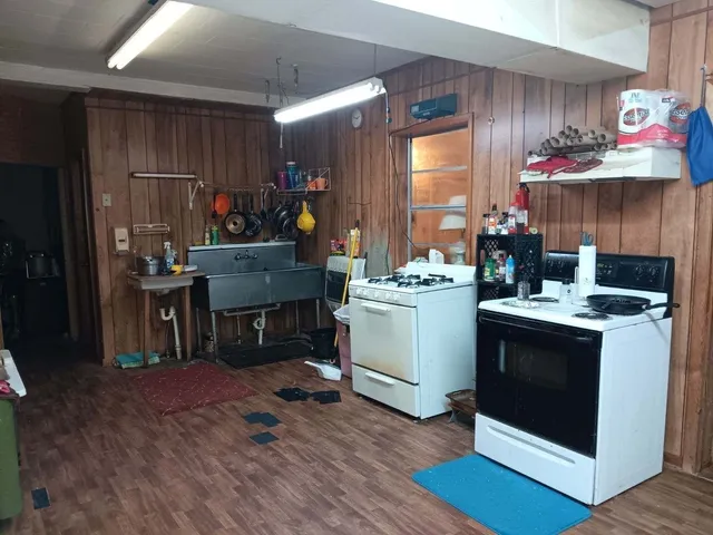a picture of a room with a white wall and a refrigerator