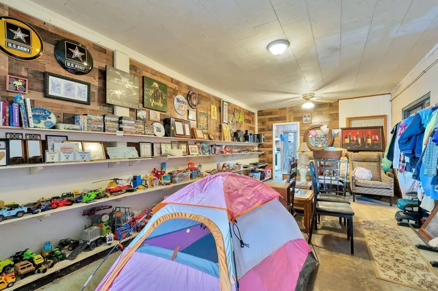 a bedroom with furniture and a book shelf
