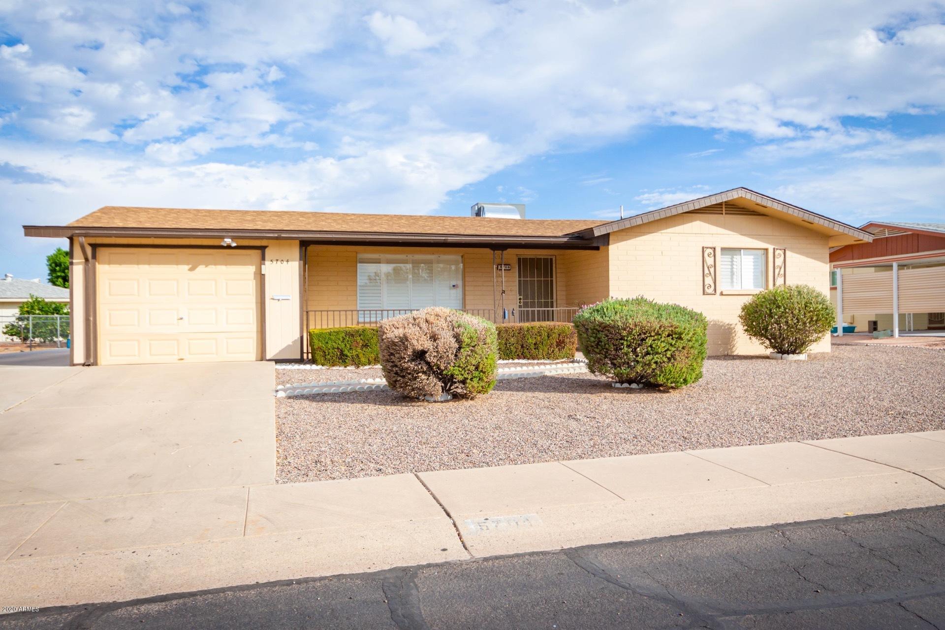 5704 East Decatur Street Mesa, AZ 85205 - Photo 3 of 40 a front view of a house with garden