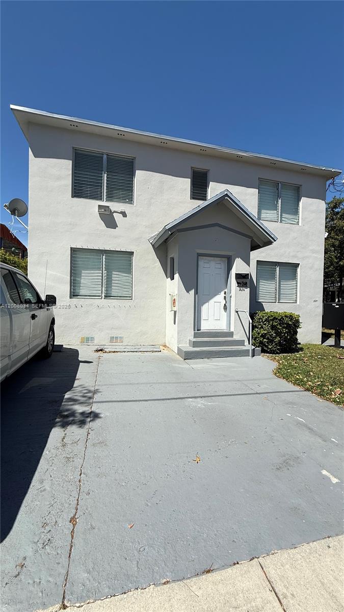 534 Southwest 6th Court, Unit 1 Miami, FL 33130 - Photo 2 of 10 a front view of a house with a yard