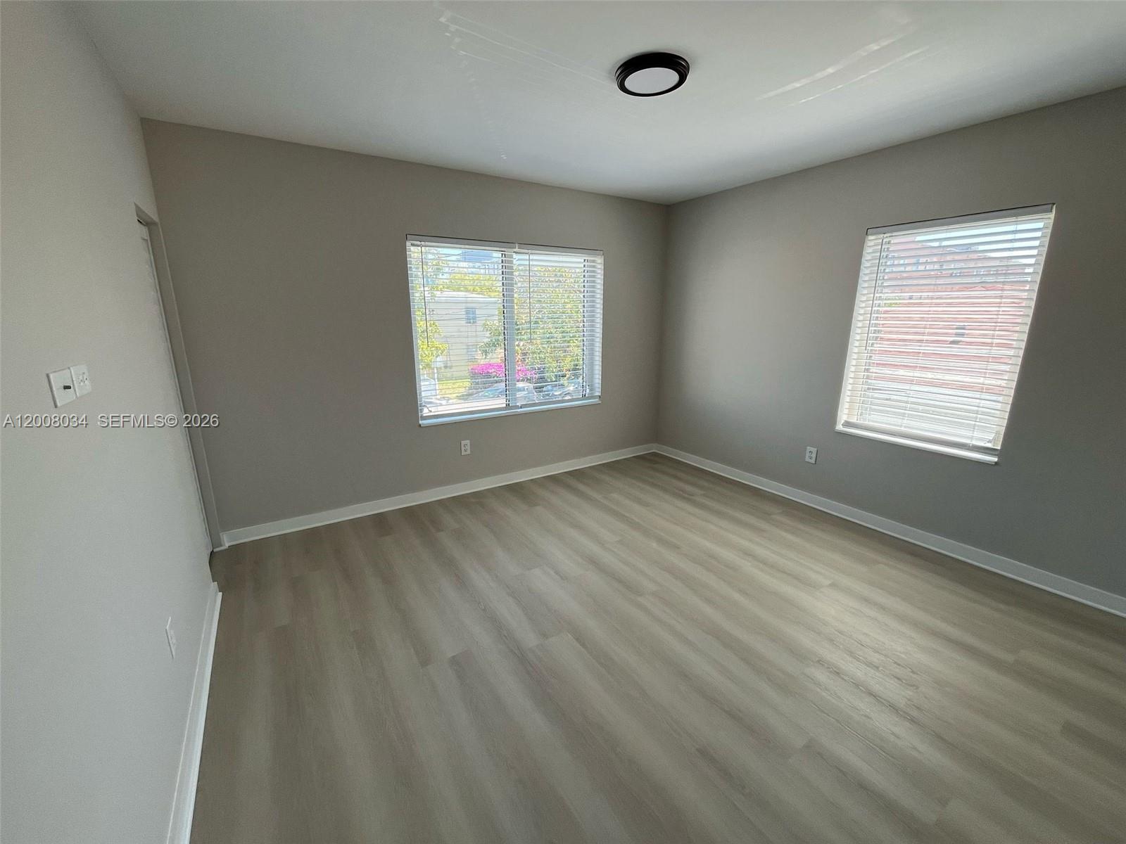 534 Southwest 6th Court, Unit 1 Miami, FL 33130 - Photo 3 of 10 wooden floor in an empty room with a window