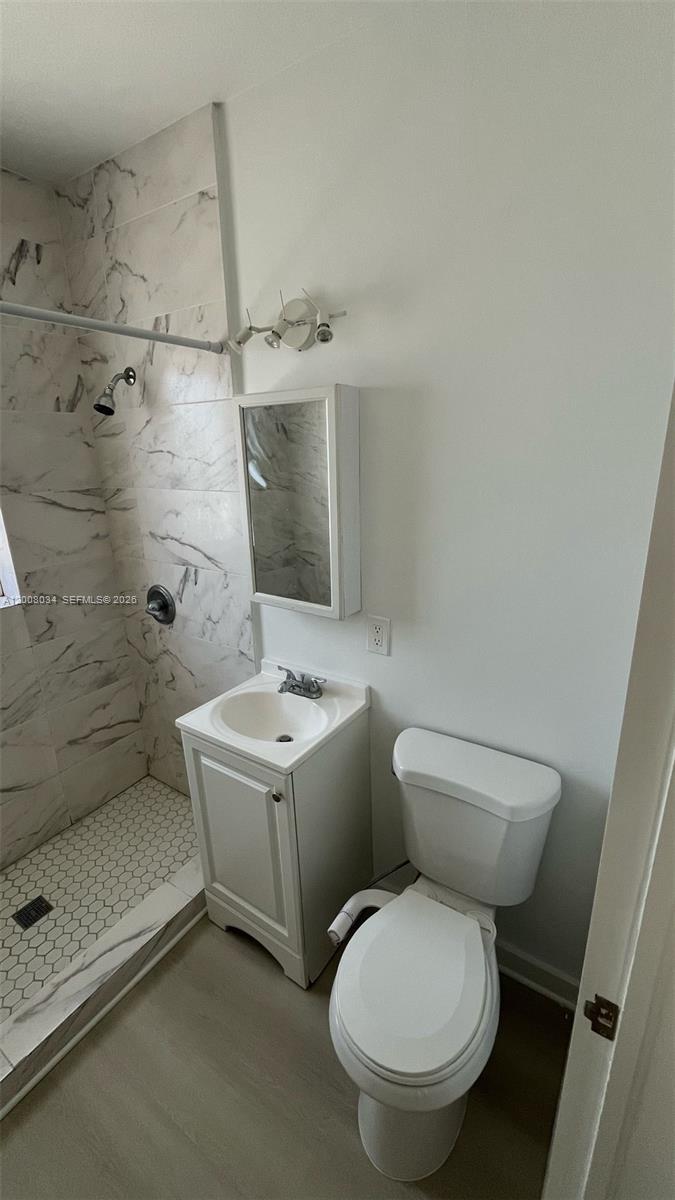 534 Southwest 6th Court, Unit 1 Miami, FL 33130 - Photo 4 of 10 a white toilet sitting next to a bathroom sink
