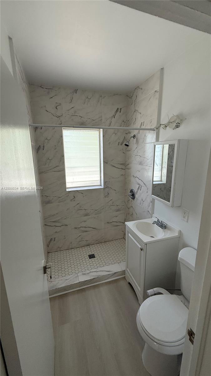 534 Southwest 6th Court, Unit 1 Miami, FL 33130 - Photo 5 of 10 a bathroom with a toilet sink and shower
