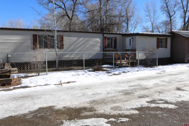 a view of house with snow on the road