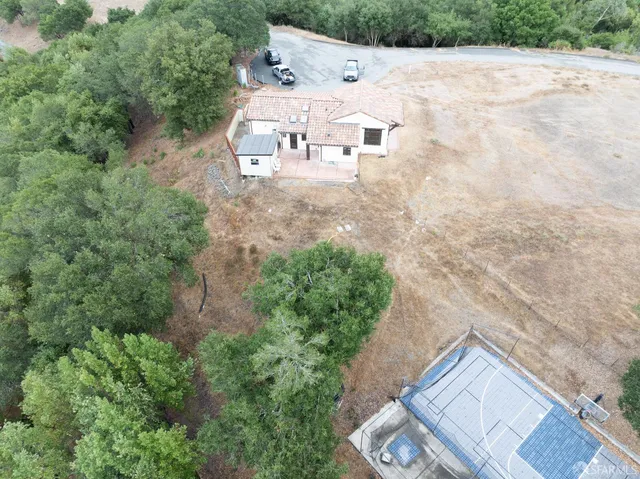 an aerial view of a house with yard