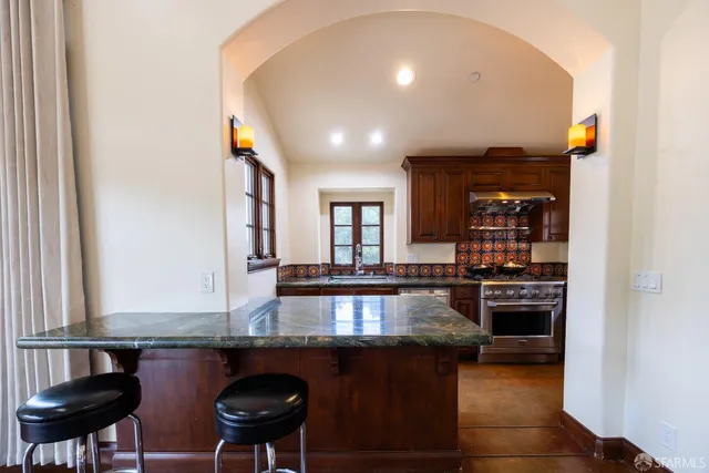 a kitchen with stainless steel appliances granite countertop a stove and a refrigerator