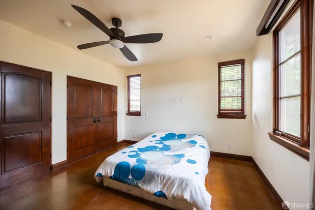 a bedroom with a bed and a window