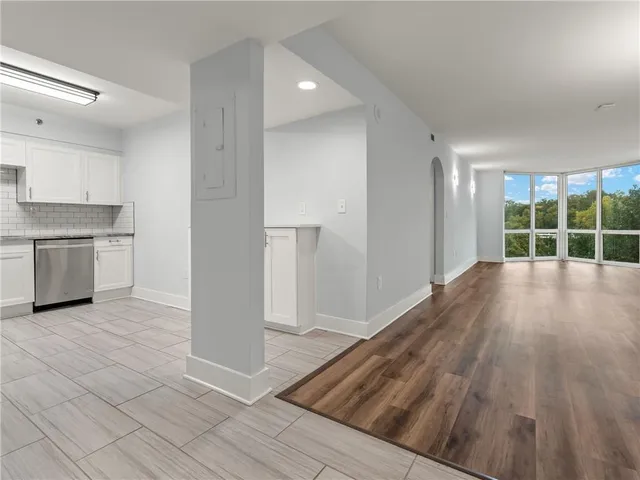 a view of a hallway with wooden floors