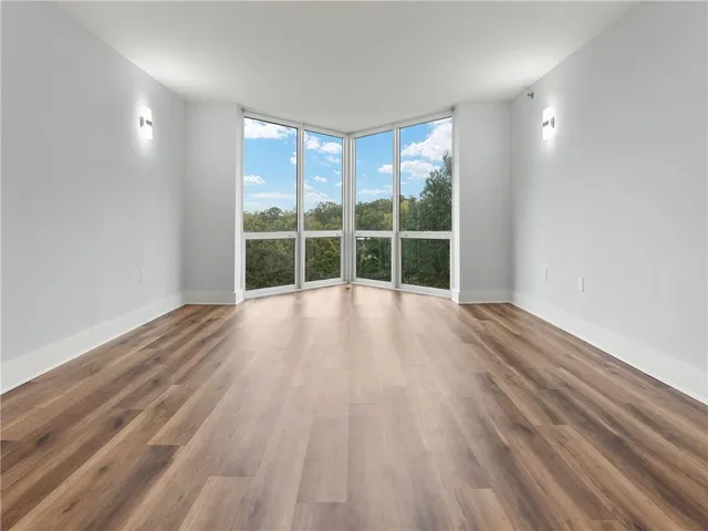 a view of a room with wooden floor and windows