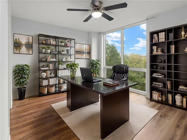 a living room with furniture and a book shelf