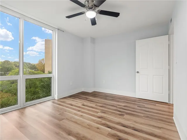 a view of empty room with wooden floor