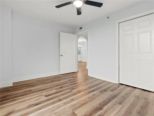 a view of an empty room and wooden floor